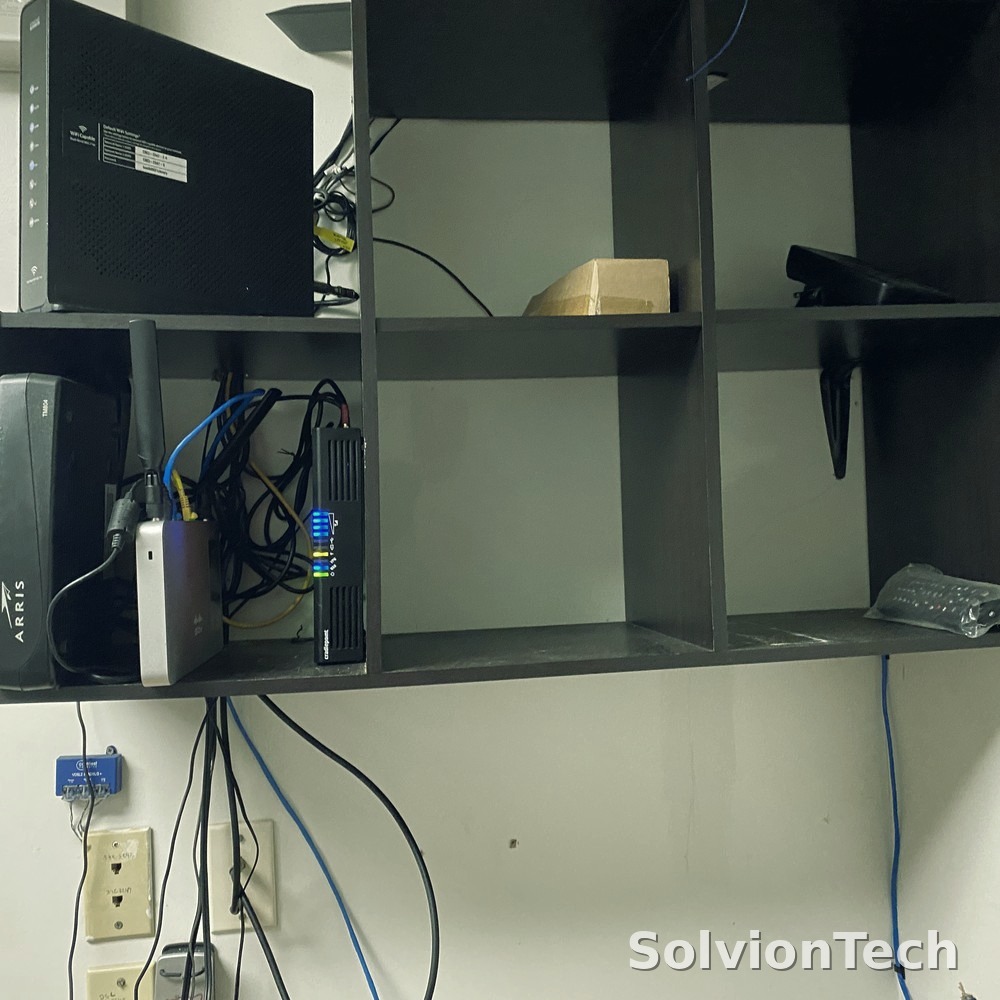 Reorganized network equipment neatly mounted on a shelf after cleanup